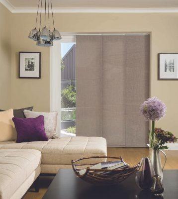 Modern beige roller blinds installed in a stylish living room for shading and privacy.