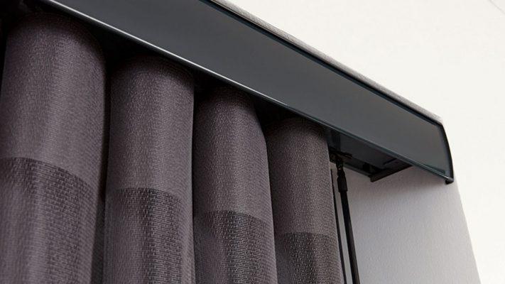 Modern outdoor shading system with dark fabric blinds and sleek black frame.
