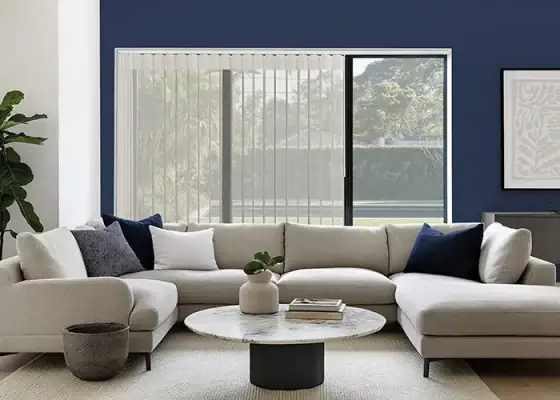 Modern living room with large window featuring sleek shading system for light control and privacy.