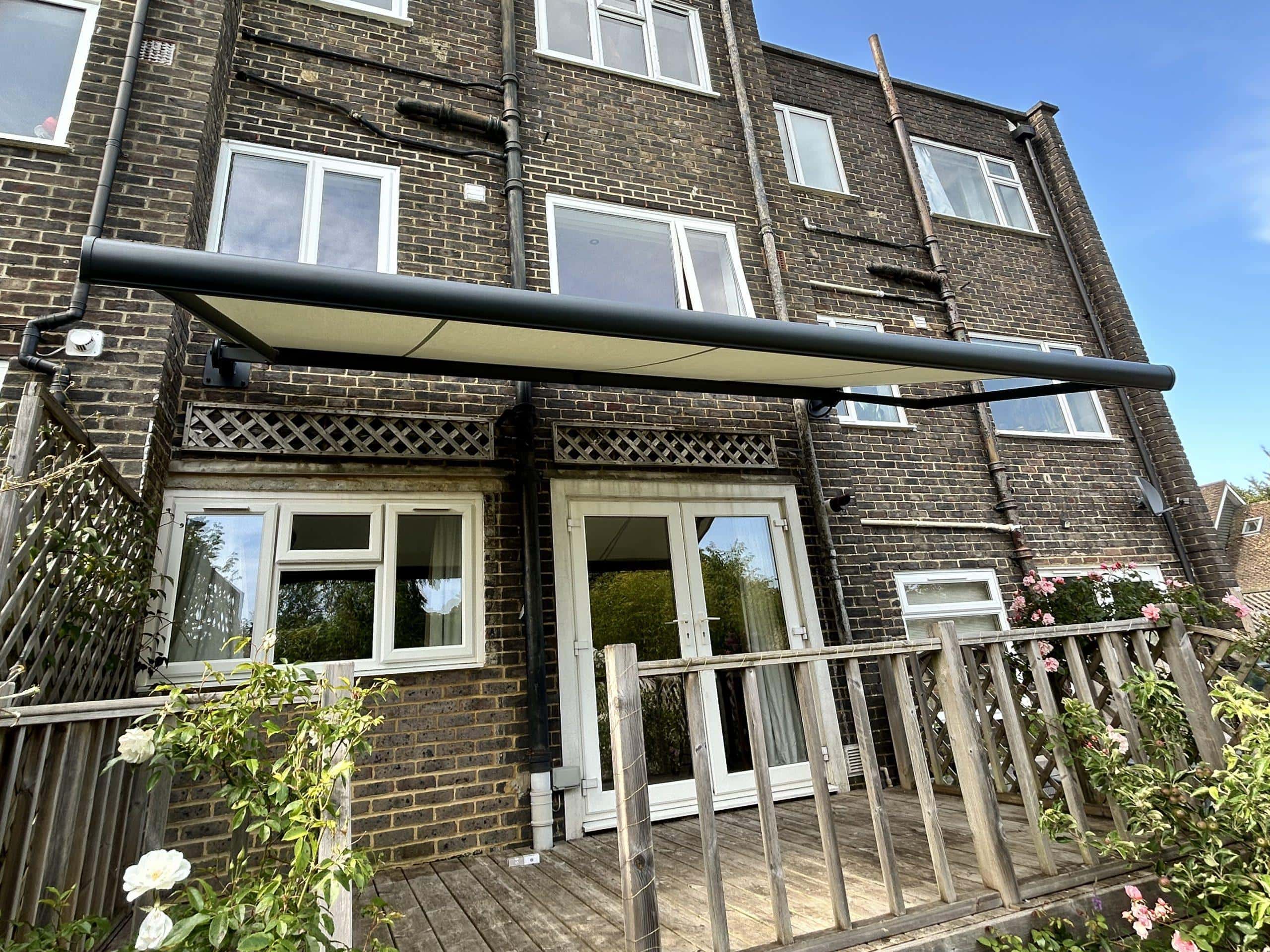 Retractable patio awning by Sovereign Shading Systems, providing shade and weather protection for ou.