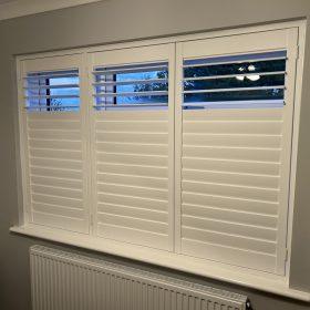 Shutter window with adjustable slats for light control and privacy.