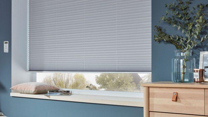 Modern grey window blinds installed in a stylish home interior.