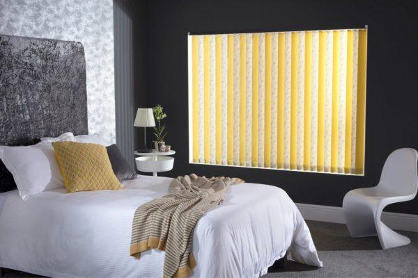 Modern yellow vertical blinds in a stylish bedroom setting for privacy and light control.