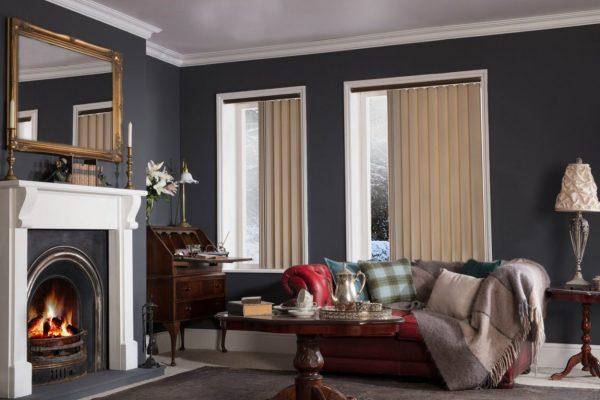 Modern interior with vertical blinds from Sovereign Shading Systems in a cosy living room.