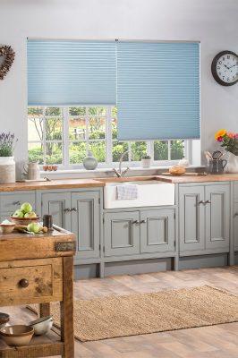 Blue window blinds from Sovereign Shading Systems, providing stylish and functional shading for kitc.