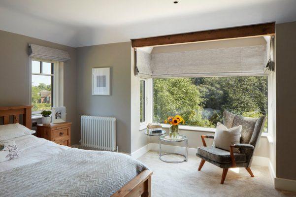 Modern interior with large window featuring Sovereign shading system for light control.