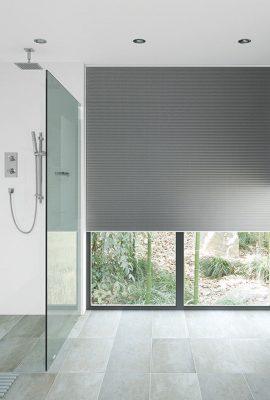 High-quality grey roller blinds for windows, providing privacy and light control in contemporary int.