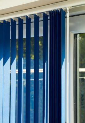 Custom blue vertical blinds for shading and privacy in modern homes.