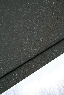 Close-up of textured, weather-resistant roofing material with speckled finish.
