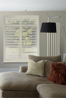 Elegant white plantation shutters providing privacy and light control in a contemporary living room.