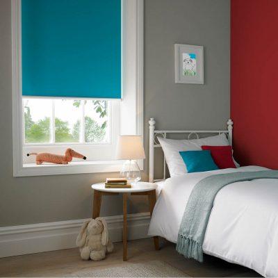 Contemporary bedroom featuring Sovereign Shading Systems blue window blinds and colourful decor.
