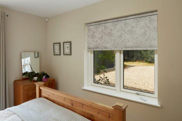 Interior window with patterned roller blind from Sovereign Shading Systems, UK.
