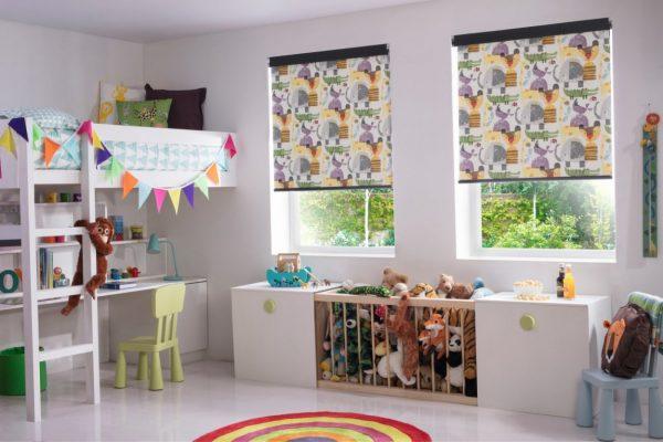 Bright kids' room with colourful patterned roller blinds by Sovereign Shading Systems.