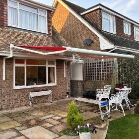 Modern outdoor patio with Sovereign shading system and garden furniture.