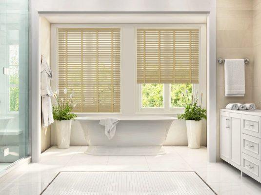 Custom wooden blinds for elegant bathroom window shading and privacy.