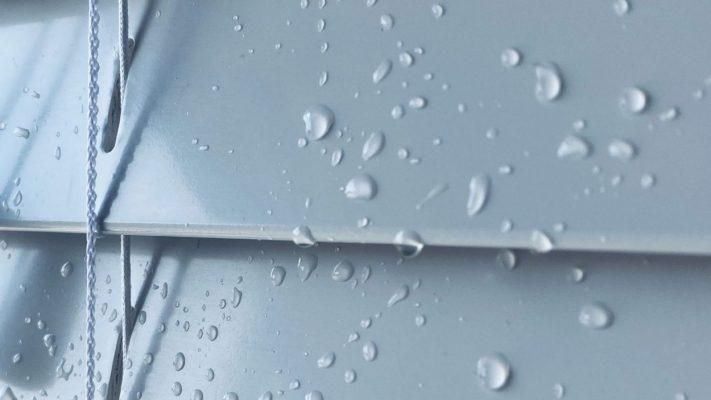 Sovereign Shading Systems with water droplets on a metallic surface, showcasing durable outdoor shad.