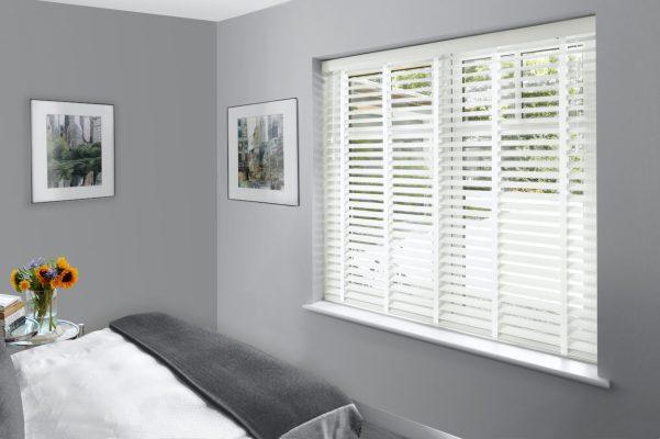 Window blinds with white slats for light control and privacy.
