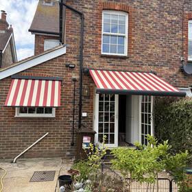 Retractable awnings providing shade and weather protection for homes.