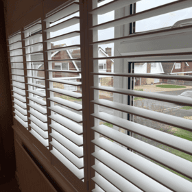 Modern white window blinds installed in a residential home.